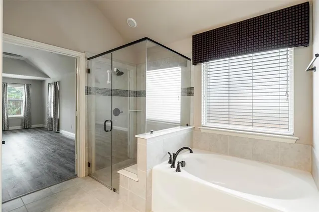 a bathroom with a bathtub and a shower