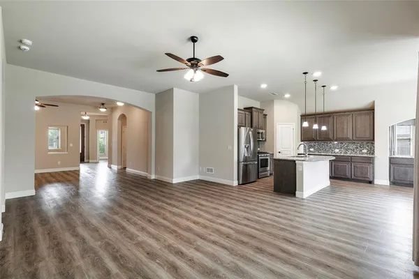 a view of a kitchen with a sink and a refrigerator
