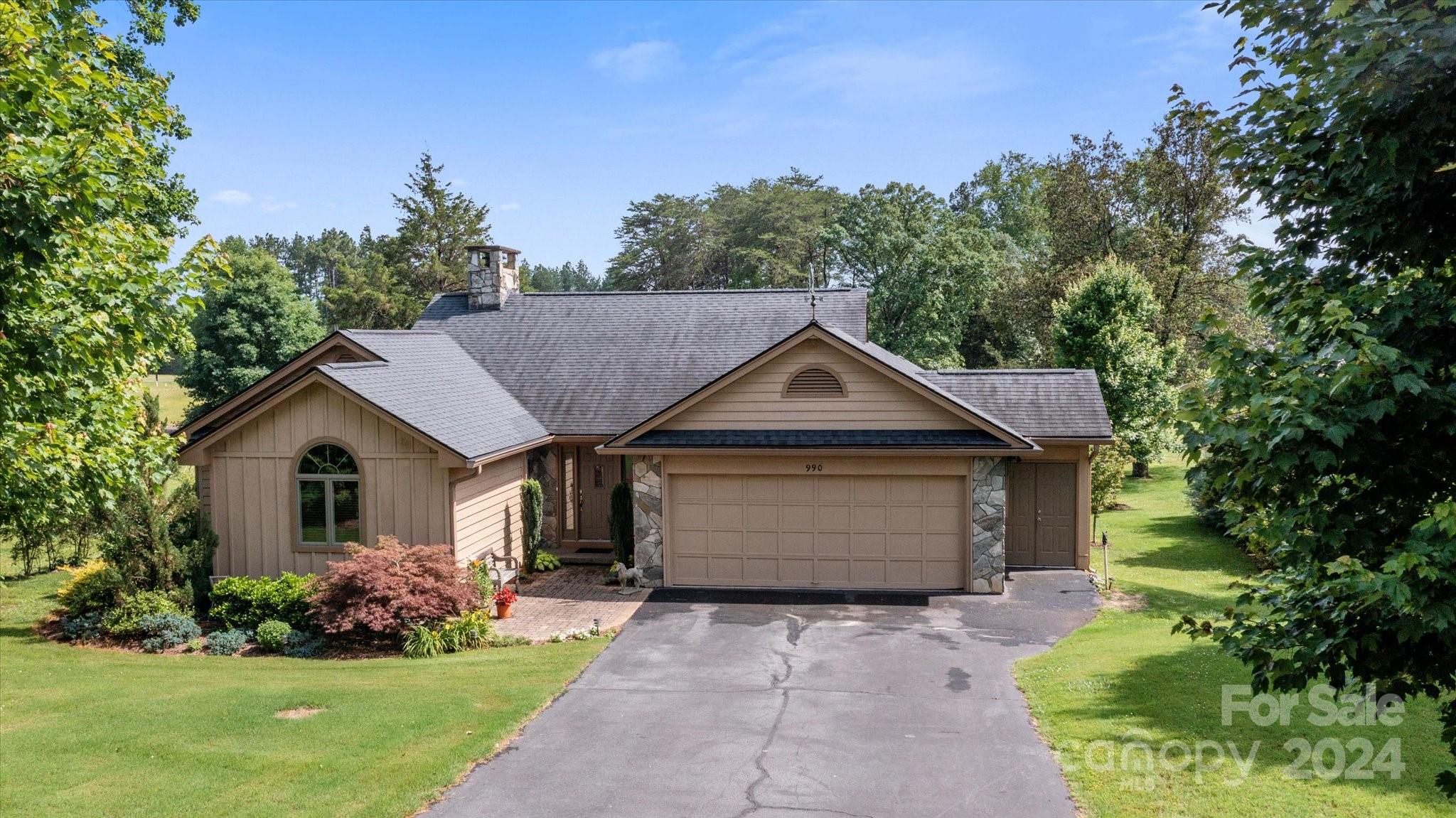 990 Club Road Tryon, NC 28782 - Photo 1 of 30 a front view of a house with a garden