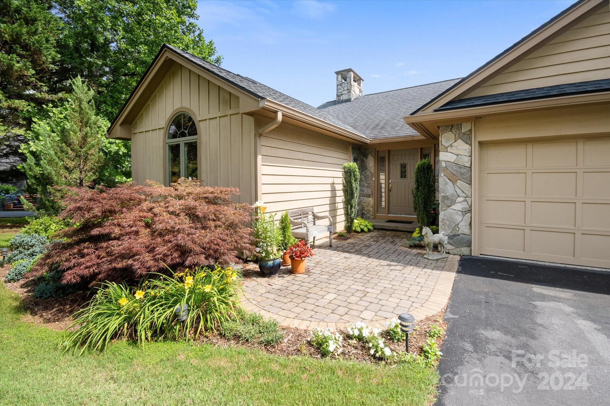 990 Club Road Tryon, NC 28782 - Photo 2 of 30 a front view of a house with garden