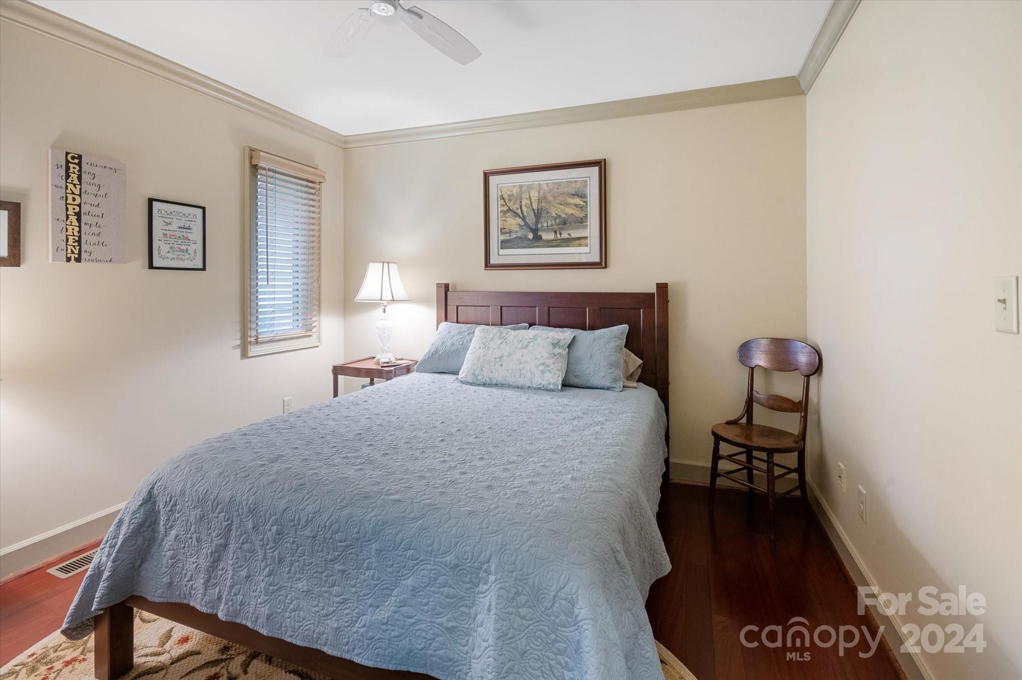 990 Club Road Tryon, NC 28782 - Photo 26 of 30 a bedroom with a bed and wooden floor