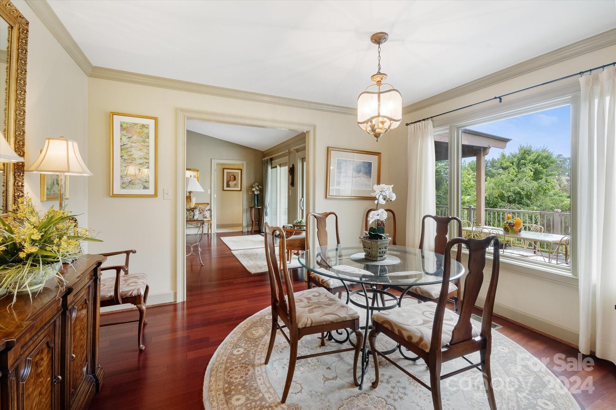 990 Club Road Tryon, NC 28782 - Photo 29 of 30 a dining room with furniture a chandelier and wooden floor