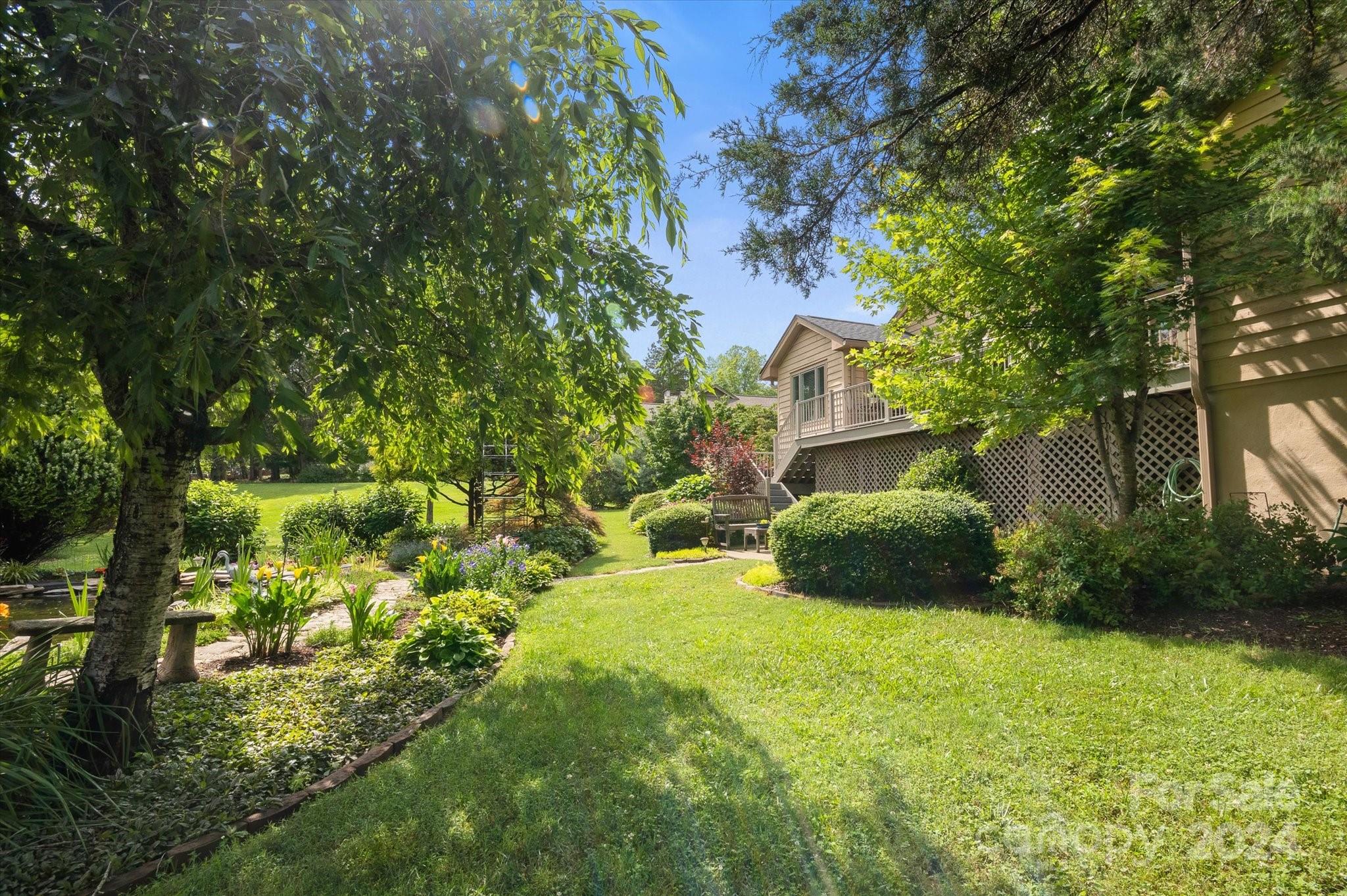 990 Club Road Tryon, NC 28782 - Photo 5 of 30 a view of a garden with a house
