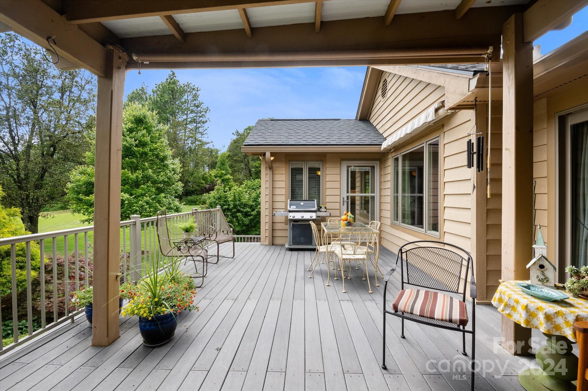 990 Club Road Tryon, NC 28782 - Photo 9 of 30 a view of a porch with furniture and wooden floor