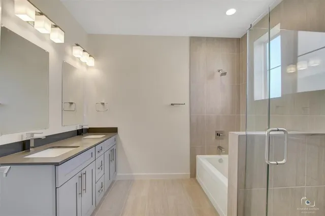 a bathroom with a granite countertop sink a shower and a mirror