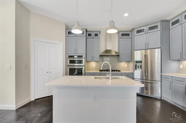 a kitchen with kitchen island a counter appliances and a refrigerator