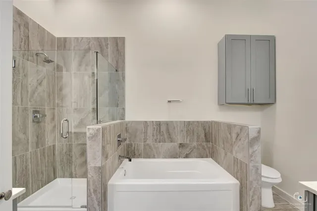a bathroom with a bathtub and shower