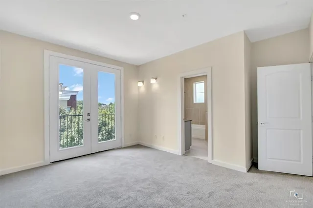 an empty room with windows and closet