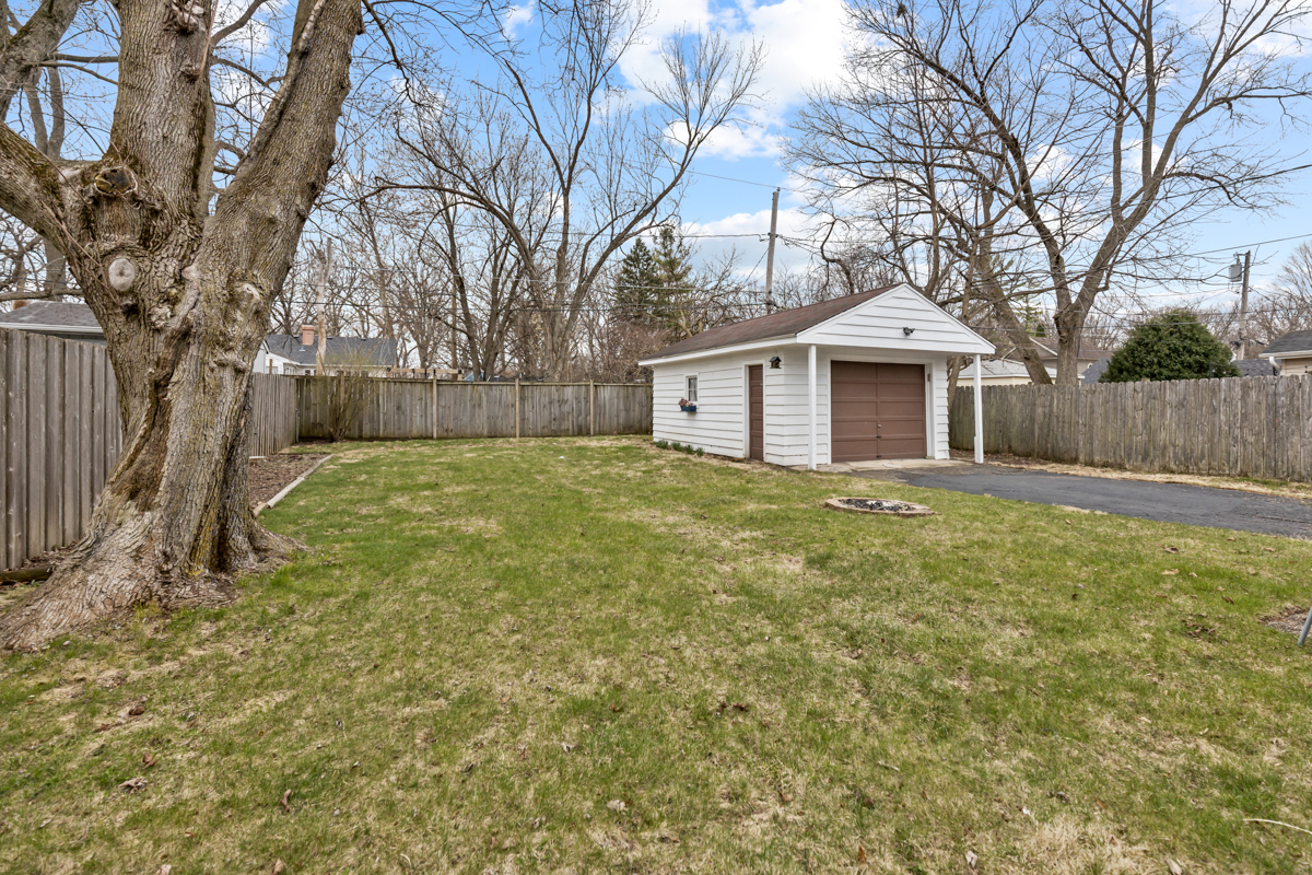 610 High Street Geneva, IL 60134 - Photo 17 of 18 a front view of a house with a yard and large tree
