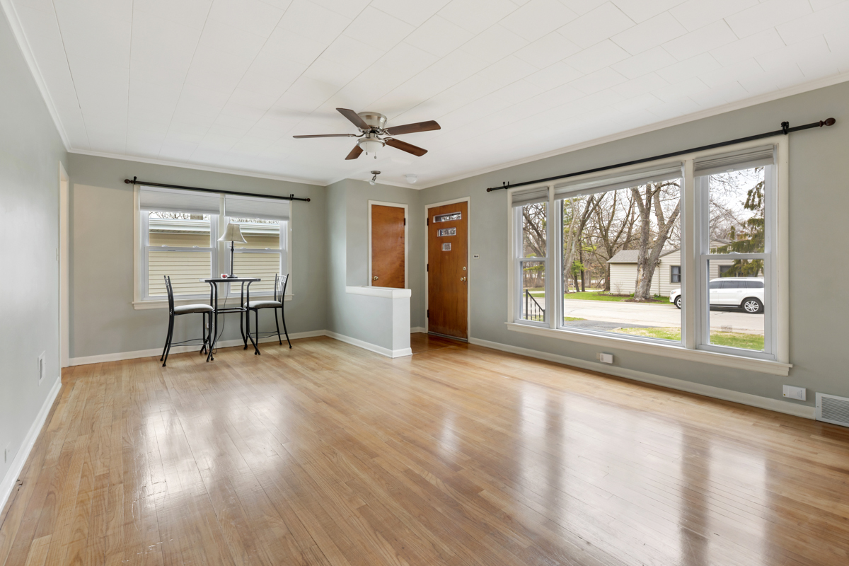 610 High Street Geneva, IL 60134 - Photo 3 of 18 a view of an empty room with a window and wooden floor