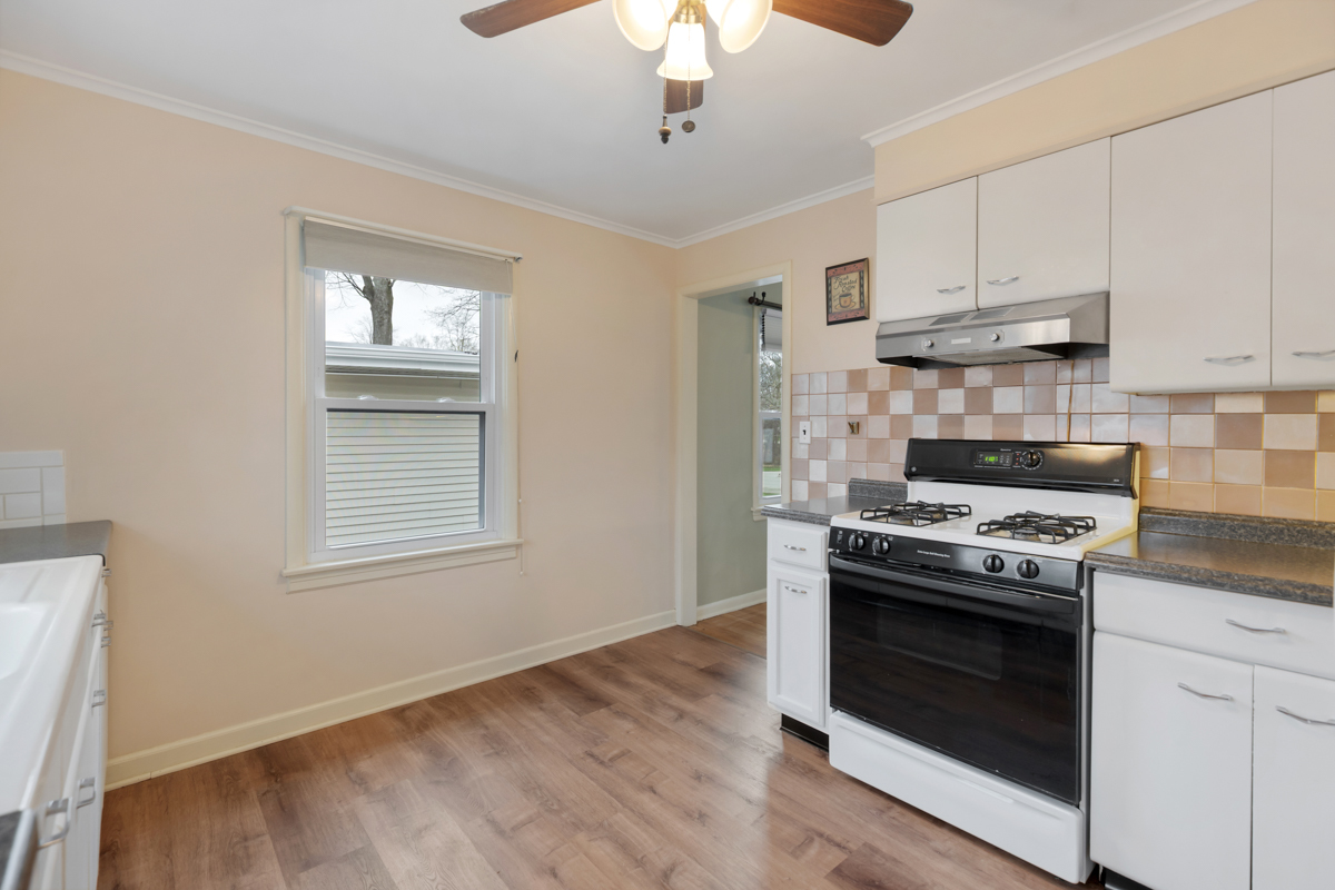 610 High Street Geneva, IL 60134 - Photo 7 of 18 a kitchen with granite countertop a stove and a sink
