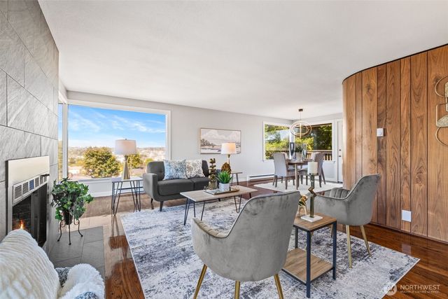 a living room with furniture a lamp a rug and a large window