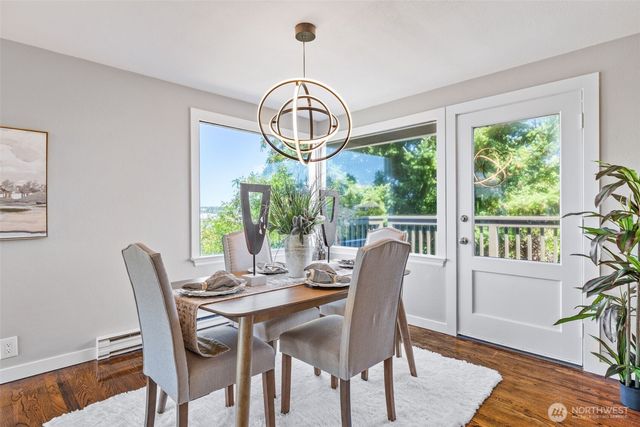 a view of a dining room with furniture window and wooden floor