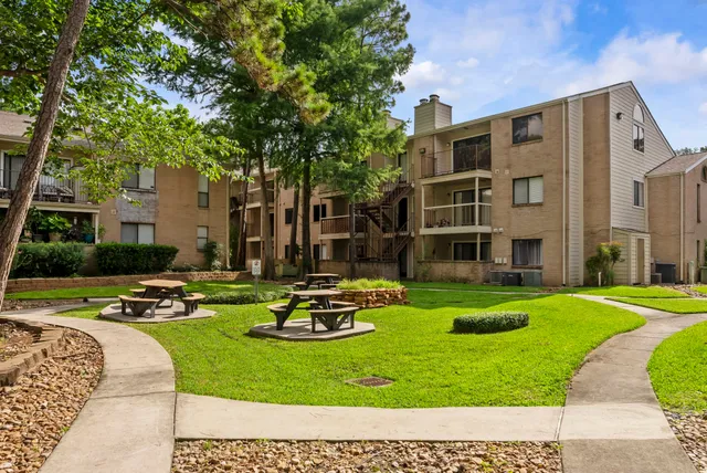 a view of a house with backyard sitting area and swimming pool