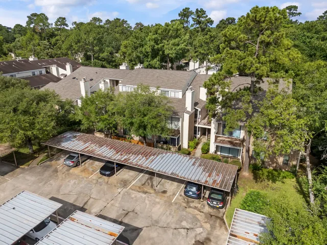 an aerial view of a house with porch and wooden floor