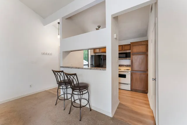 a view of a room with furniture and wooden floor