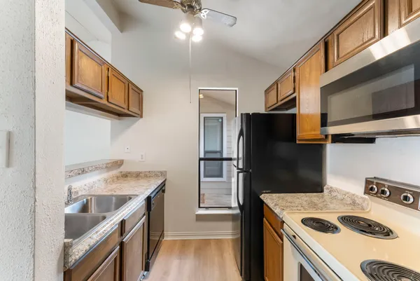 a kitchen with a sink a stove and refrigerator