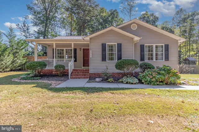 a front view of a house with a yard and porch