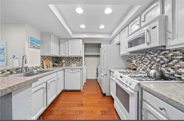a kitchen with stainless steel appliances granite countertop a stove and a sink