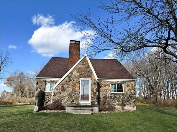 a view of house with yard