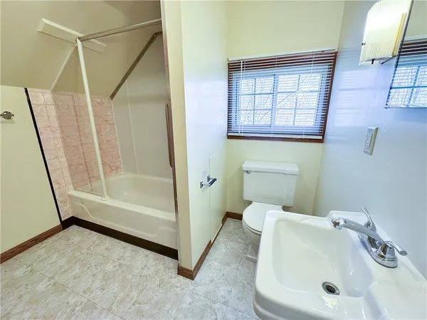 a bathroom with a sink a toilet and bathtub