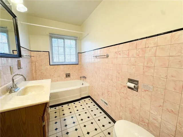 a kitchen with granite countertop a refrigerator a sink and dishwasher a stove top oven with wooden floor