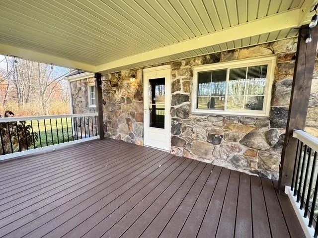 a view of front door deck and patio