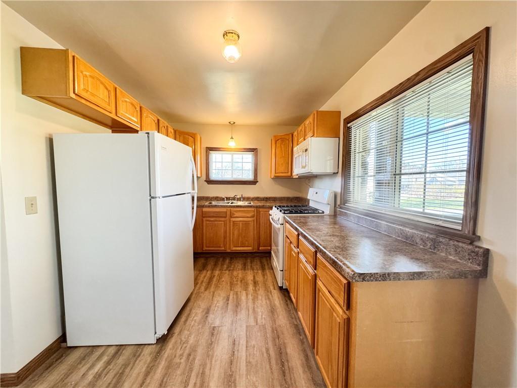 618 New Castle Road Butler, PA 16001 - Photo 7 of 23 a kitchen with a refrigerator a sink and a stove