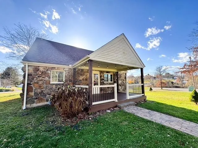 a view of a house with backyard porch and furniture
