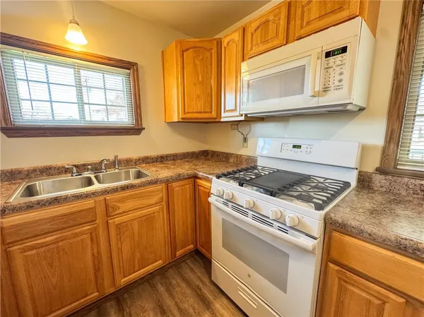 a kitchen with stainless steel appliances granite countertop a stove and a microwave
