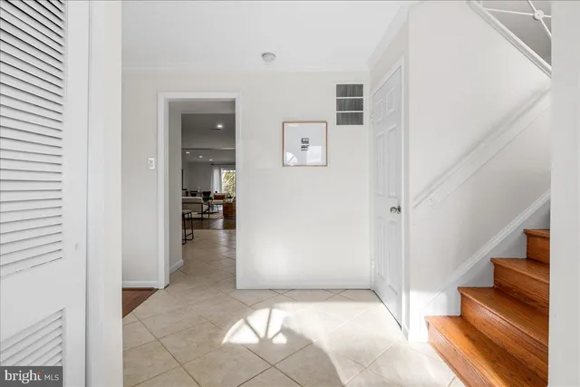 a dining room with furniture a large window and chandelier