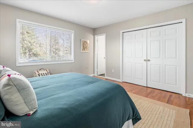 a view of a house with a yard and large tree