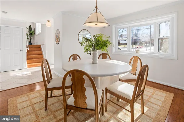 a view of a dining room with furniture and a chandelier