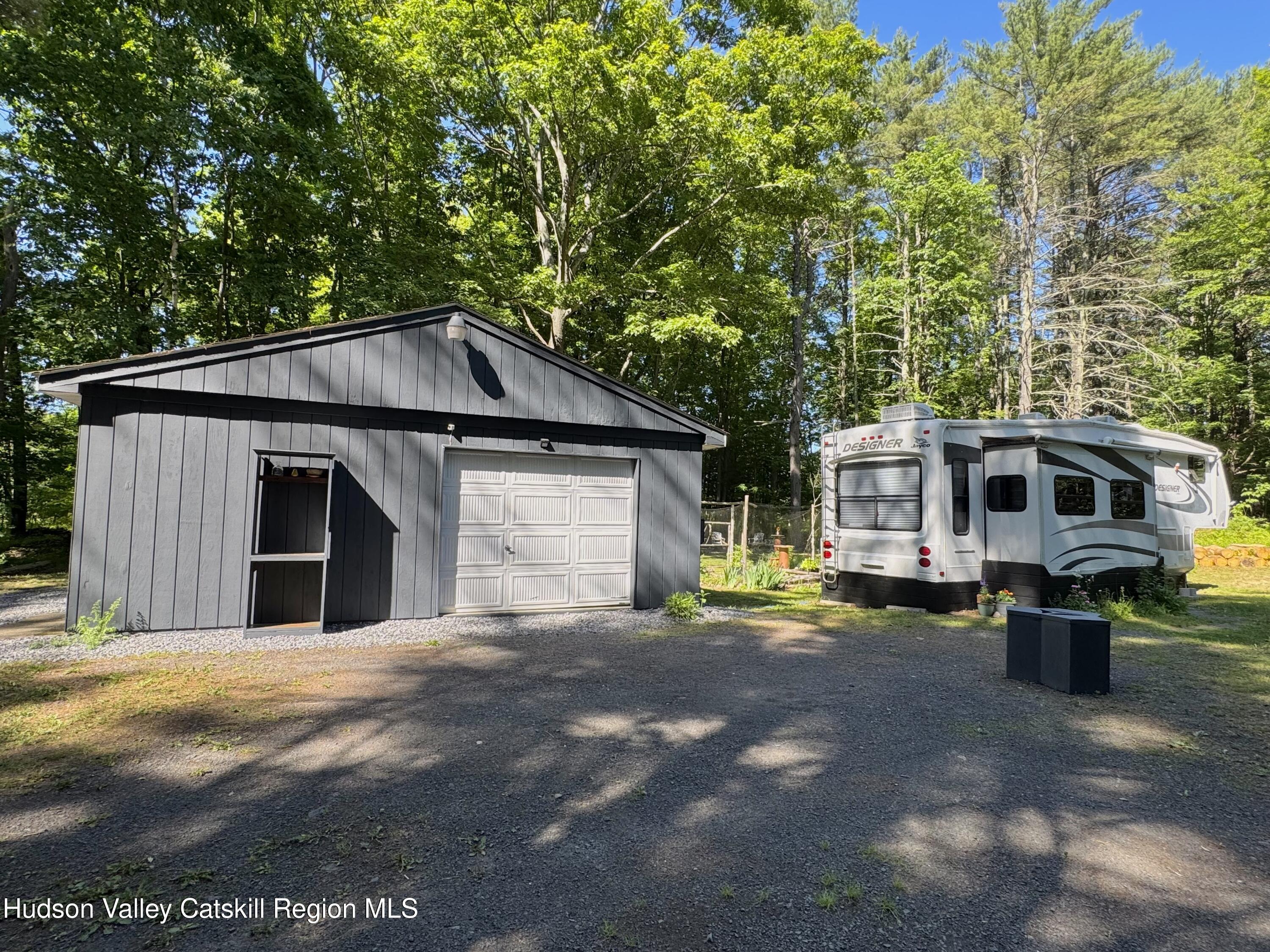 177 Webber Road Earlton, NY 12058 - Photo 36 of 50 a front view of a house with a yard and garage