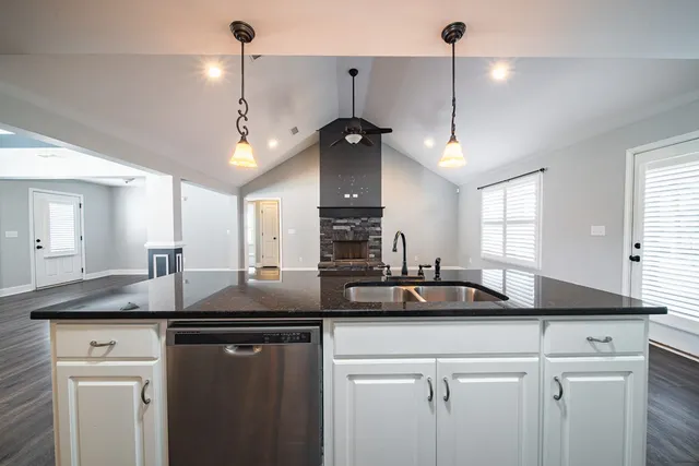 a kitchen with a sink a counter space and cabinets