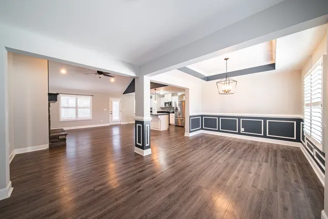 a view of a room with wooden floor