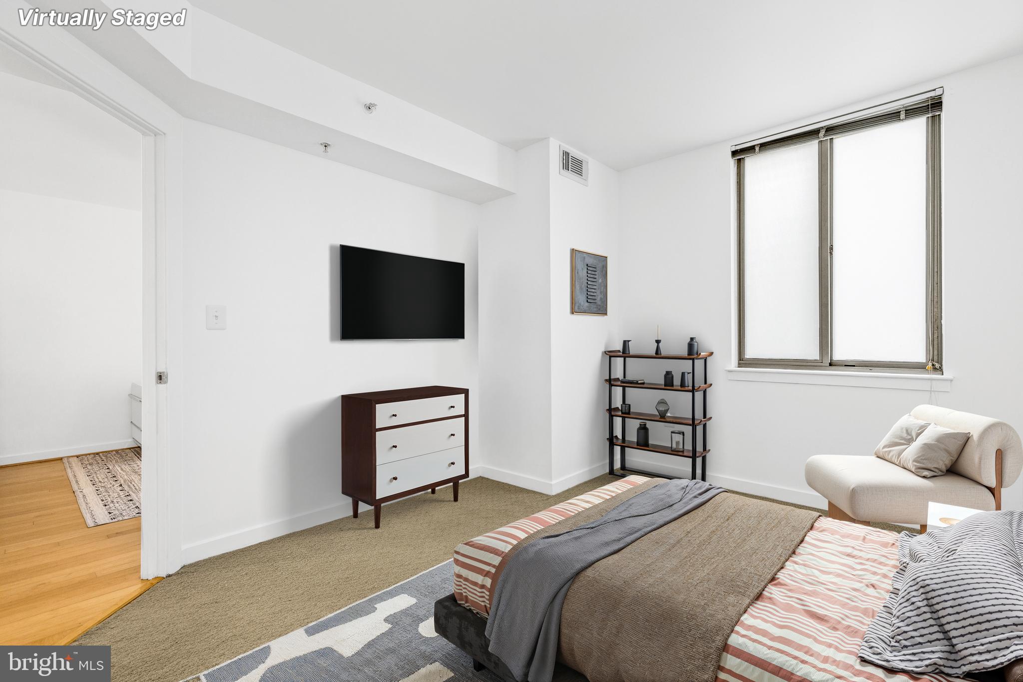 1000 New Jersey Avenue Southeast, Unit 608 Washington, DC 20003 - Photo 12 of 28 a bedroom with a bed and a flat tv screen on a dresser