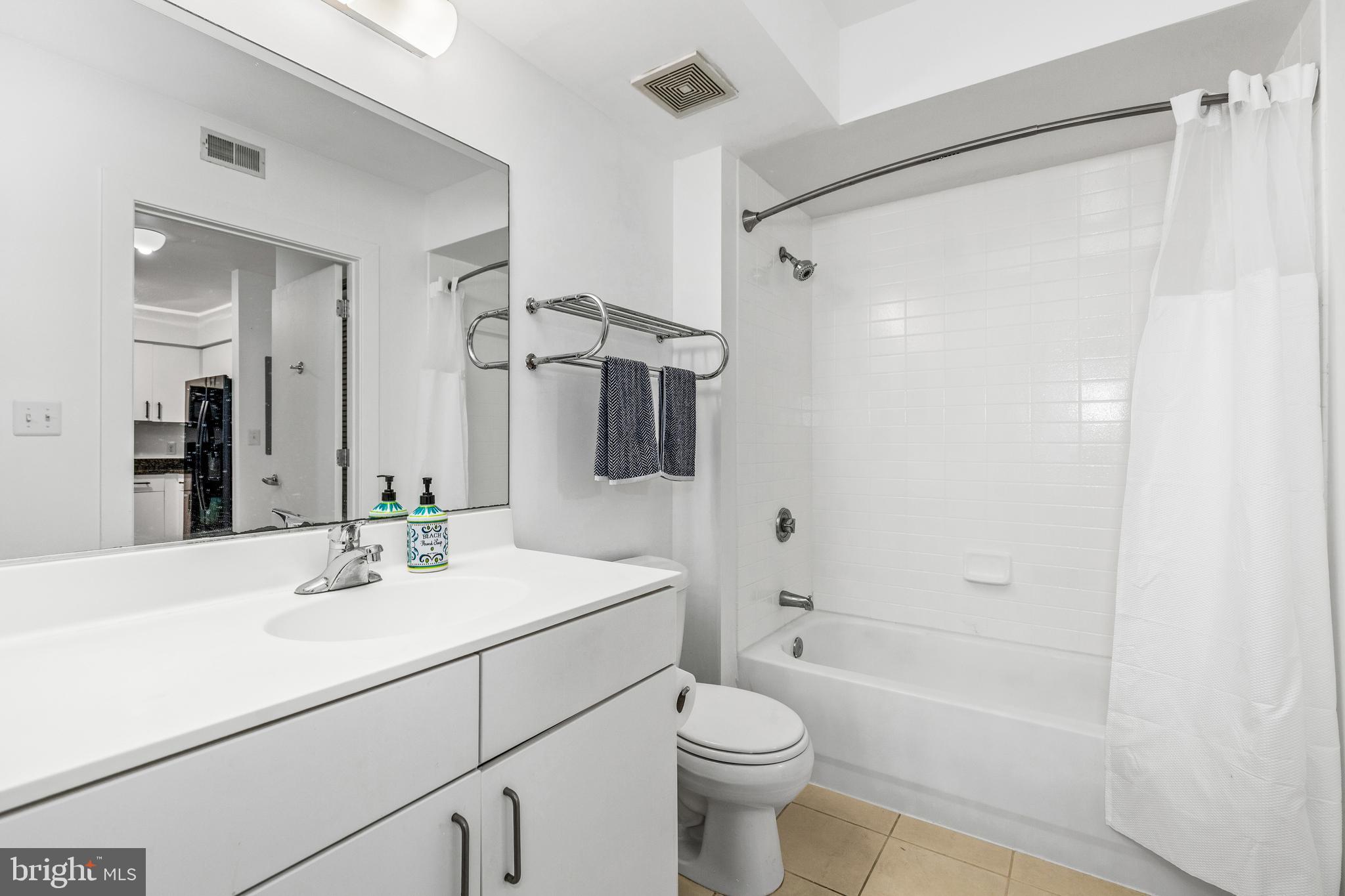1000 New Jersey Avenue Southeast, Unit 608 Washington, DC 20003 - Photo 16 of 28 a bathroom with a sink toilet a mirror and shower