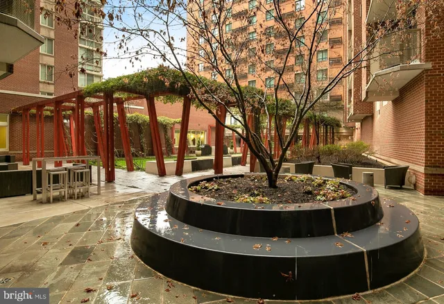 a view of a patio with couches and a fireplace
