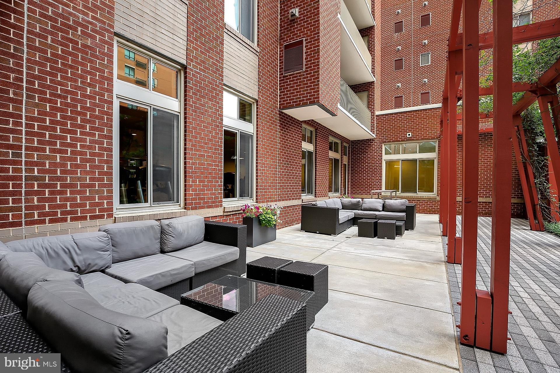 1000 New Jersey Avenue Southeast, Unit 608 Washington, DC 20003 - Photo 27 of 28 a view of a patio with couches and a fireplace