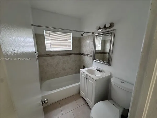 a bathroom with a sink toilet tub and shower