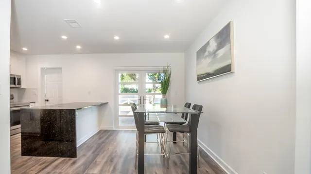 a view of a dining room with furniture and wooden floor
