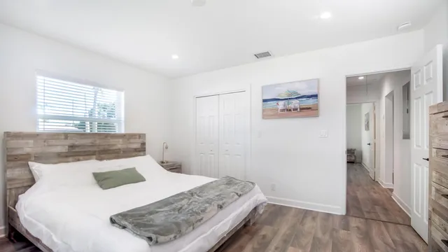 a bedroom with a bed and a window