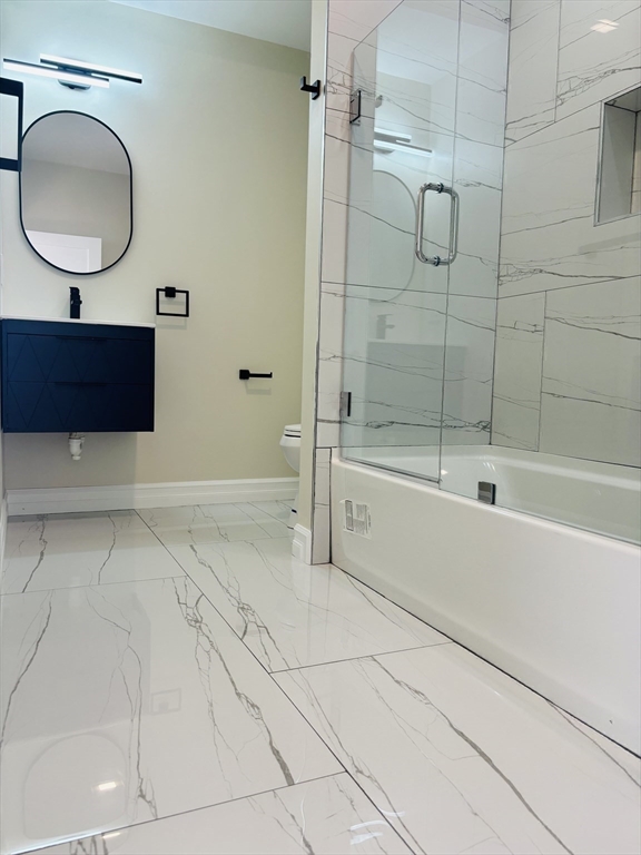 19 Maverick Street, Unit 19 Dedham, MA 02026 - Photo 11 of 13 a bathroom with a sink a toilet and shower
