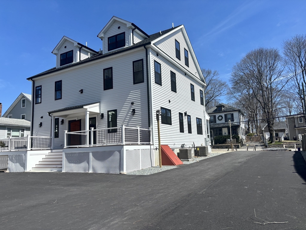 19 Maverick Street, Unit 19 Dedham, MA 02026 - Photo 2 of 13 a view of a white building among the street with houses