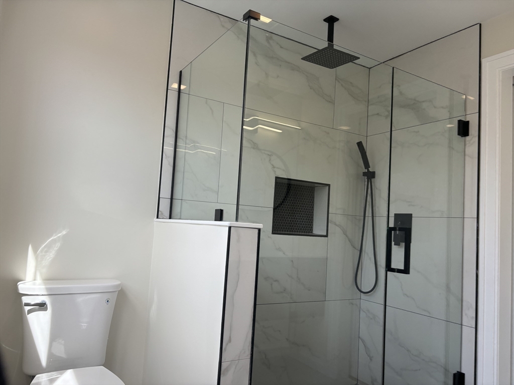 19 Maverick Street, Unit 19 Dedham, MA 02026 - Photo 9 of 13 a bathroom with a shower and a toilet