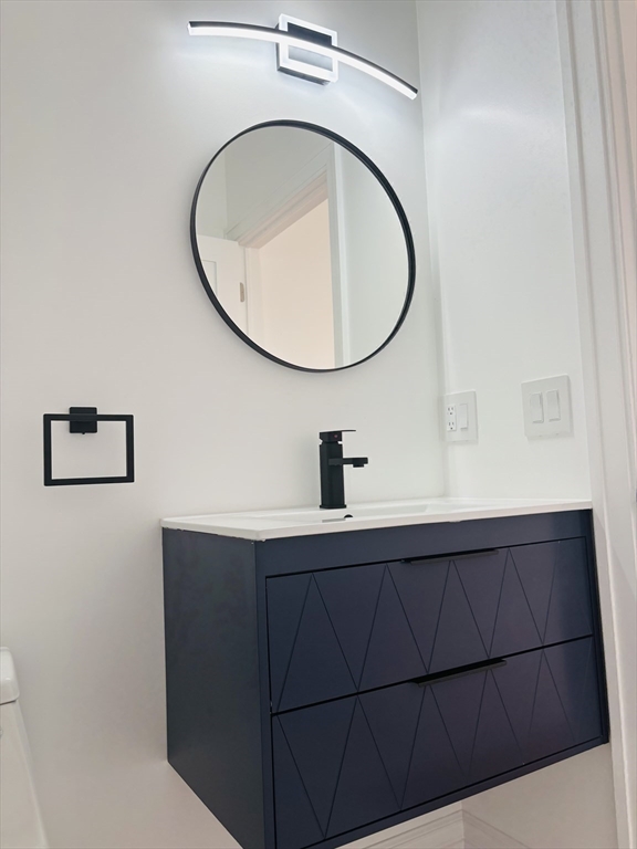 19 Maverick Street, Unit 19 Dedham, MA 02026 - Photo 10 of 13 a bathroom with a sink and a mirror