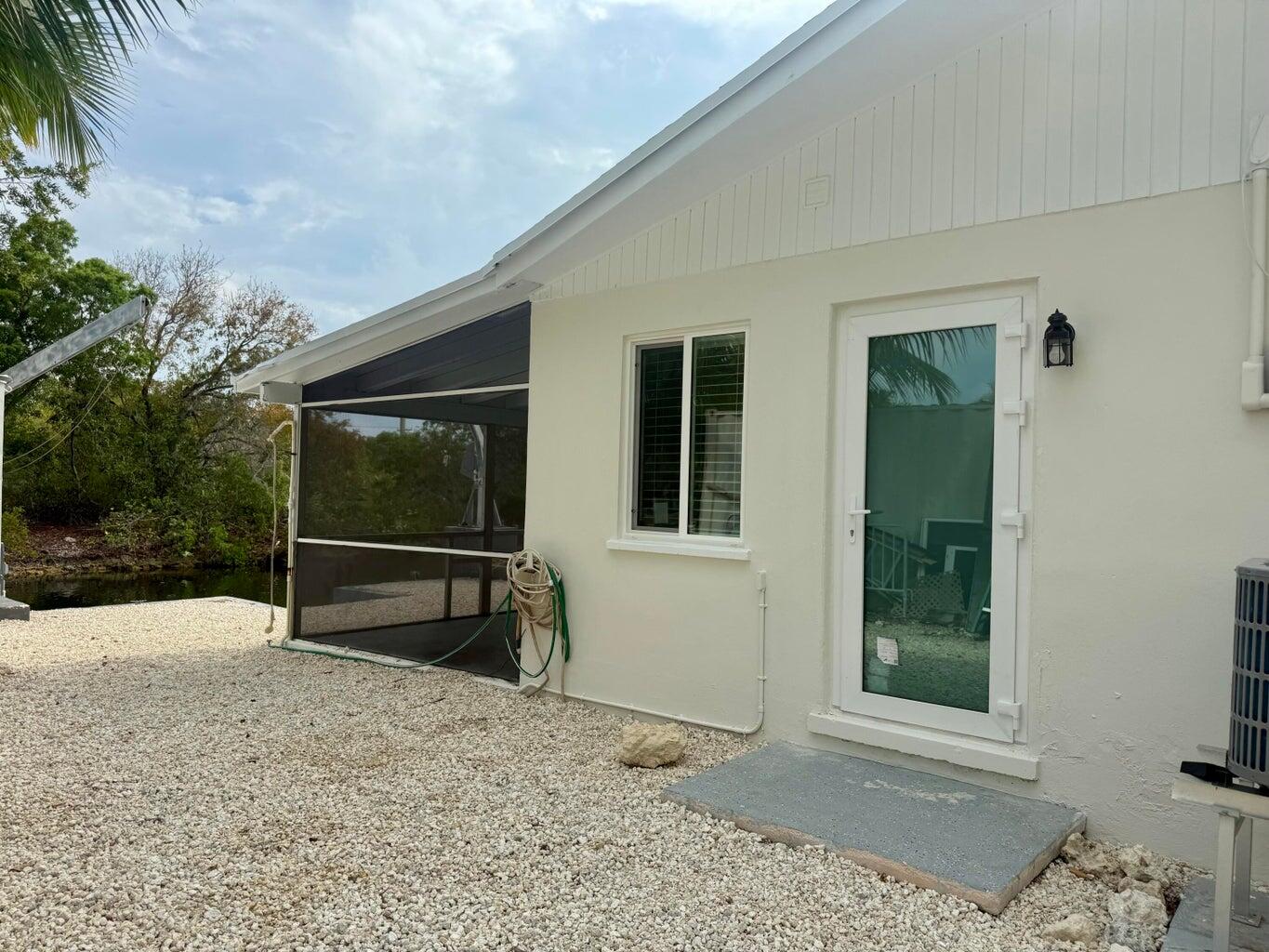 29656 Constitution Avenue Big Pine Key, FL 33043 - Photo 6 of 19 a backyard of a house with barbeque oven and brick wall