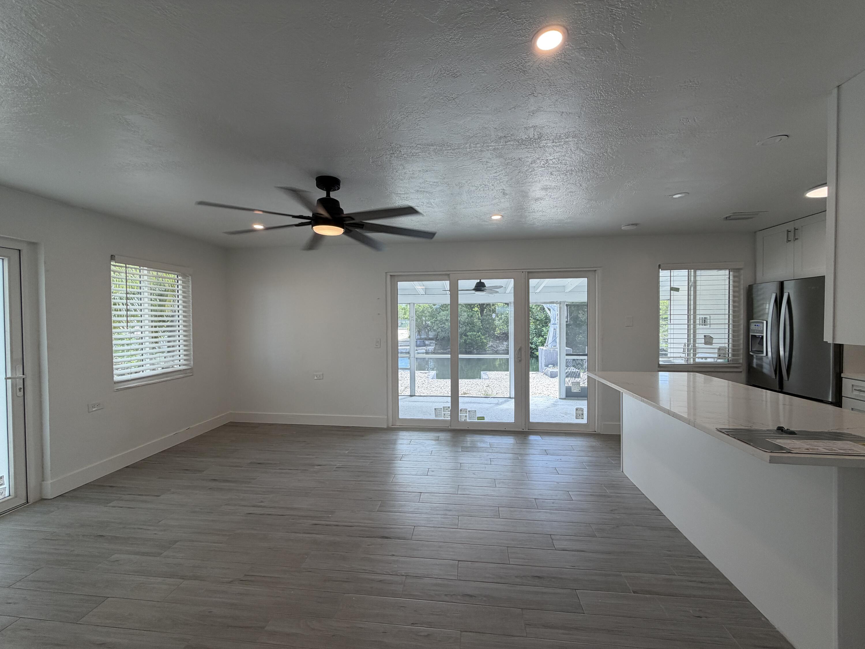 29656 Constitution Avenue Big Pine Key, FL 33043 - Photo 7 of 19 an empty room with wooden floor and windows