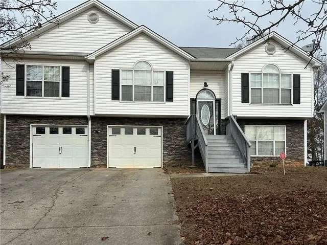 a front view of a house with a yard and garage